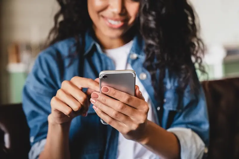 Booking a 13SICK home-doctor visit on a phone — the first step of the after-hours service.